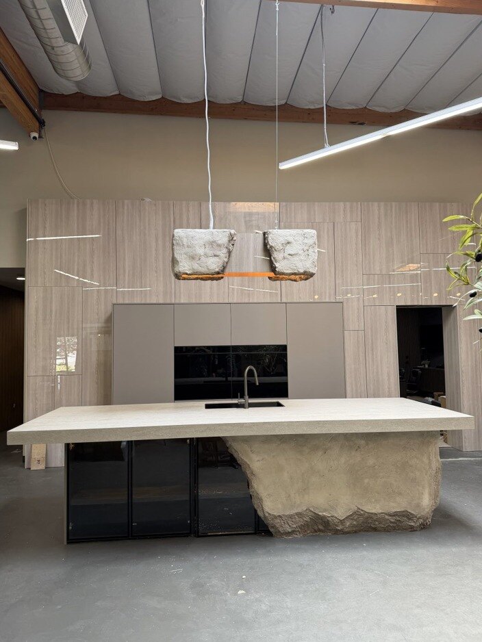 Wide view of the monolithic kitchen island under vaulted ceilings
