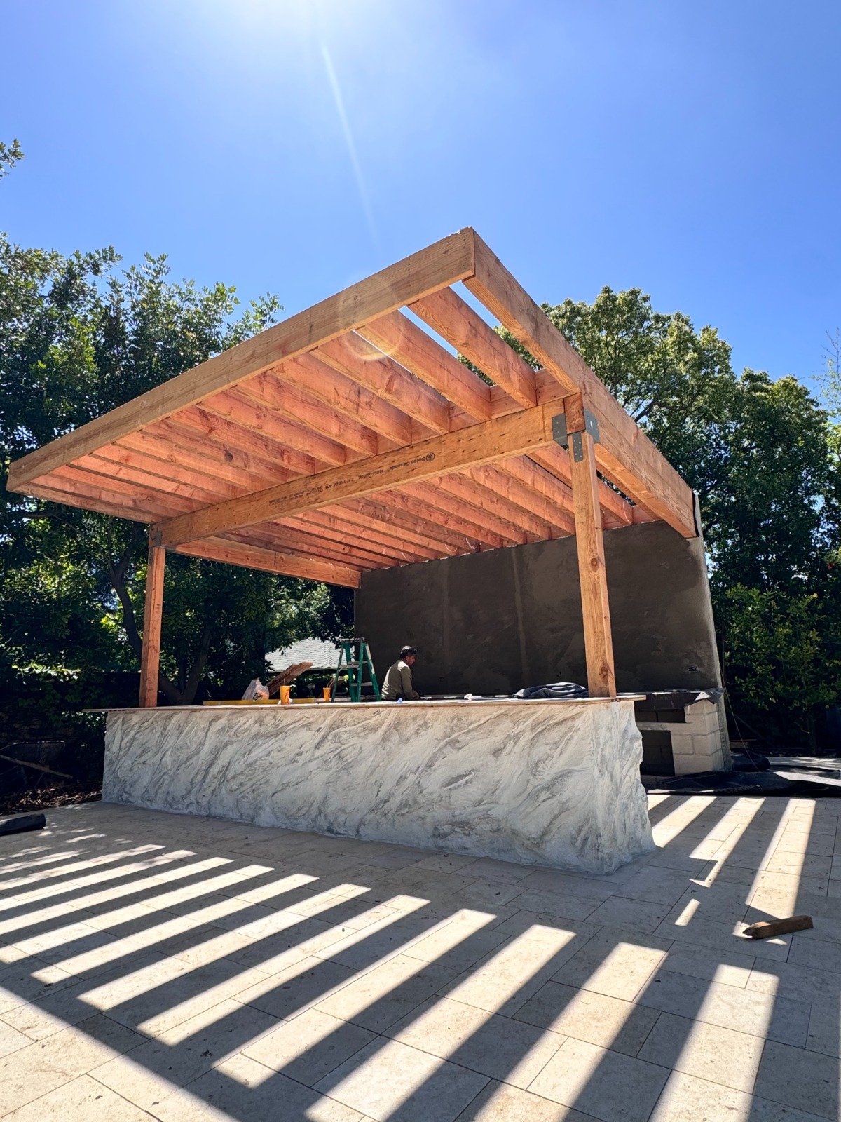 Outdoor pergola and stone bar from the side