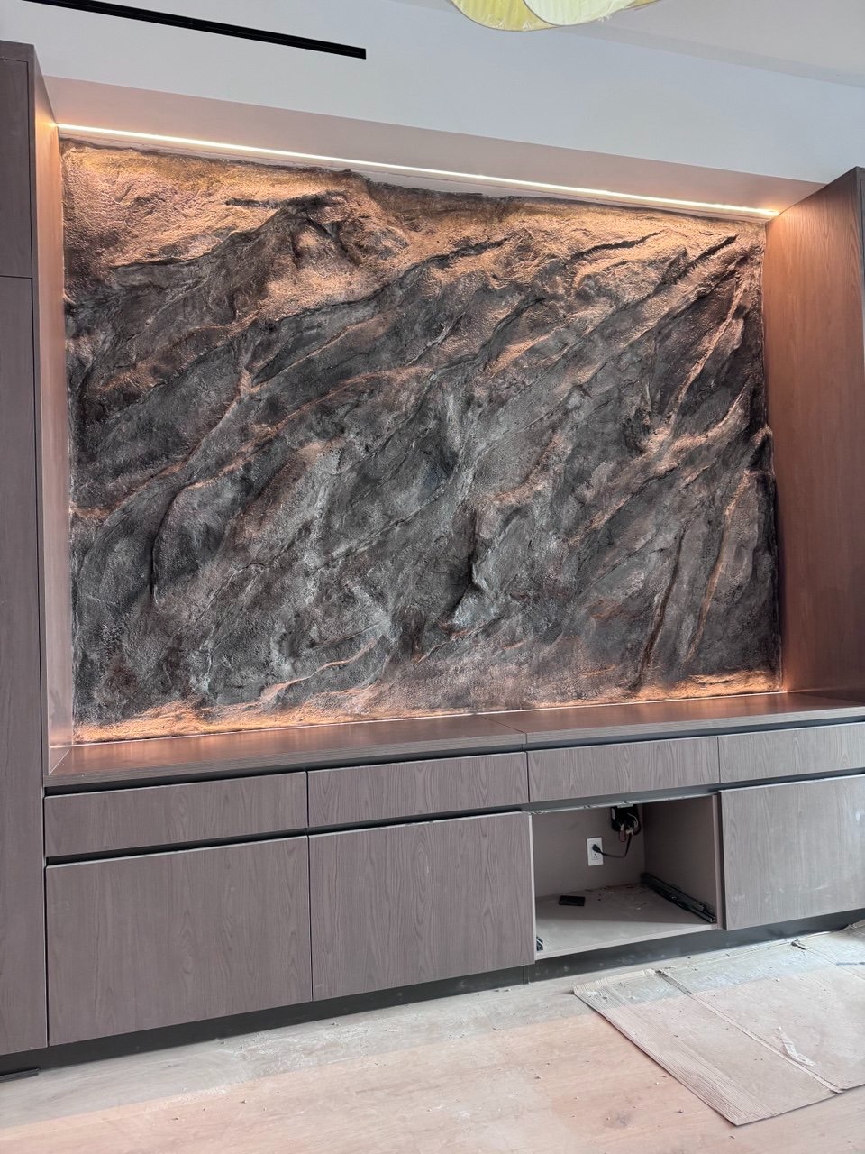 Volcanic lava stone wall installation in Hidden Hills residence