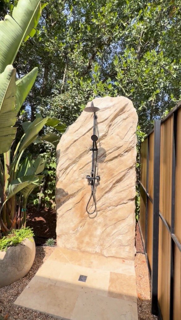 Outdoor stone shower in a tropical Malibu garden