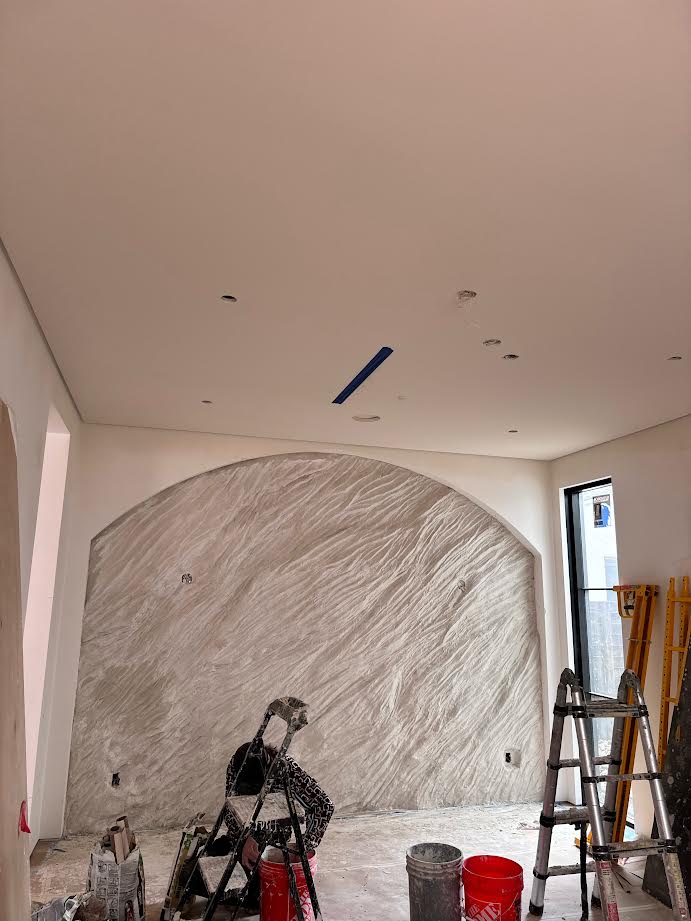 Finished arched white sculpted stone wall