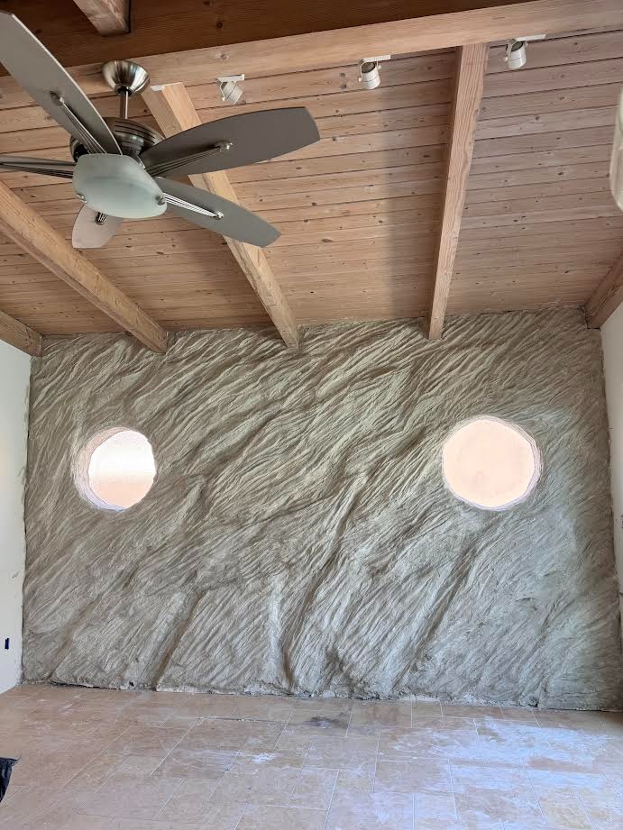 Wind-textured wall with circular cutouts