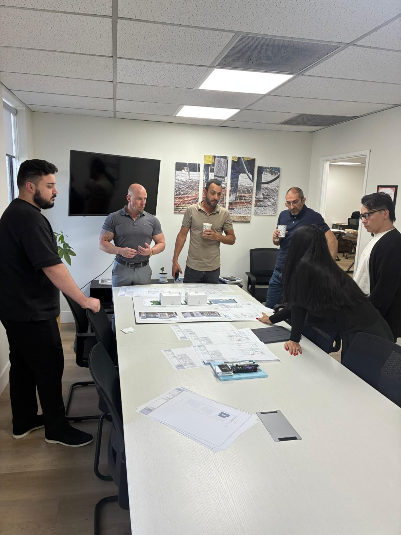 Facade team reviewing architectural plans on a design table